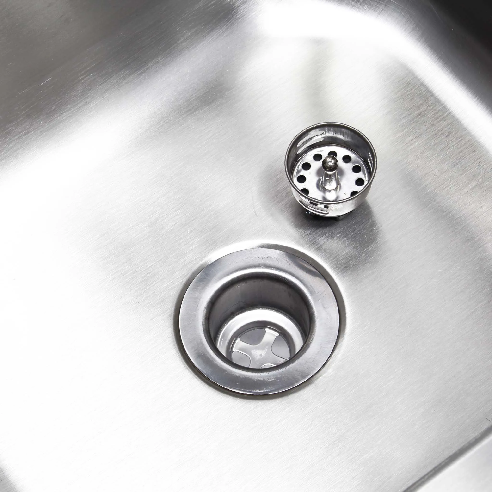 a sink drain with a hole in it