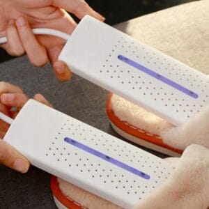 a pair of hands holding white electronic devices